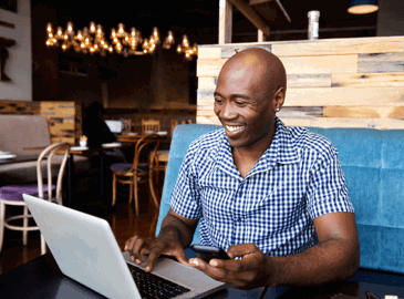 Man using a laptop in a cafe