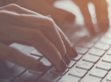 Person typing on a keyboard