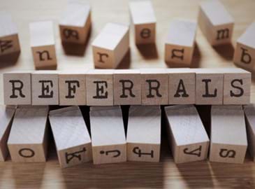 Wooden blocks spelling out the word referrals