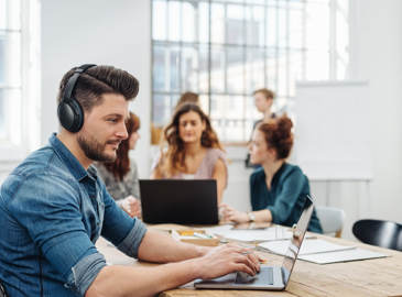 Man with headphones working on laptop