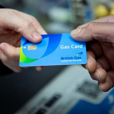 Customer hands British Gas card to a shop worker