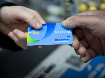 Customer hands British Gas card to a shop worker