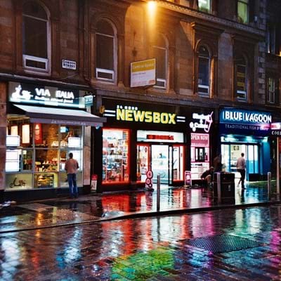 Newsbox retail shopfront at night 
