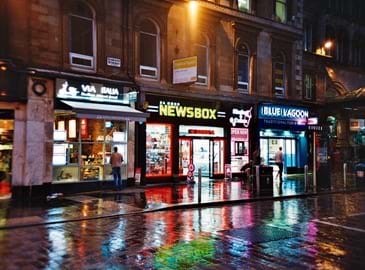 Newsbox retail shopfront at night 