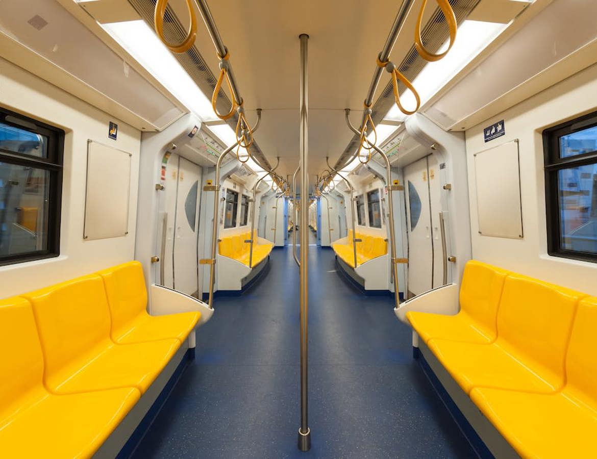 Inside of an empty, modern, train carriage with bright yellow seats