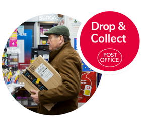 A man at a post office counter, holding a parcel and wearing a coat and flat cap